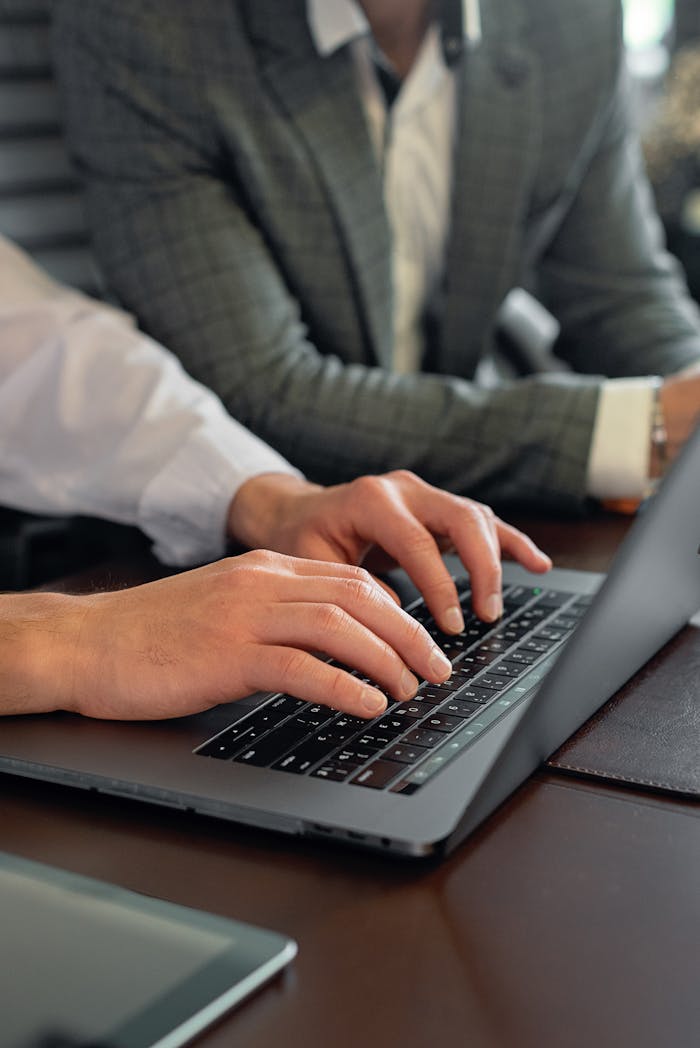 A Businessperson Typing on a Laptop